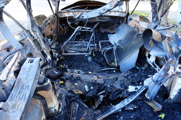 Burnt car on a city street