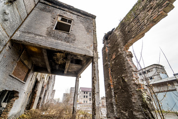 Fototapeta na wymiar Abandoned industrial building. Ruins of an old factory