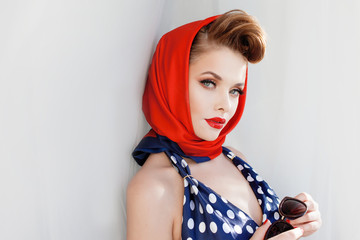young beautiful woman with red lipstick and a headscarf.