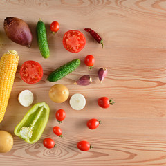 Vegetables laid out on a wooden table. Flat lay,top view. Free space for text.