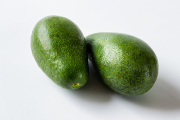 Two large avocados on white background.