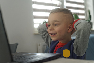mały chłopiec jest zadowolony, ma laptopa  © ftomasz