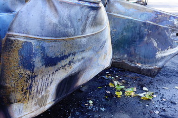 Burnt car on a city street