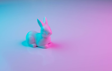 Obraz na płótnie Canvas White Easter bunny with colorful ultraviolet holographic neon lights. Creative concept.