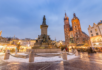 Krakow, main square winter evening, christmas fairs, Mickiewicz statue and St Mary church