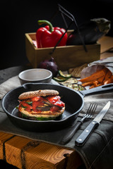 Homemade chicken burger on cast-iron frying pan