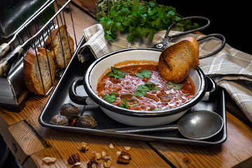Spicy soup Kharcho on wooden background