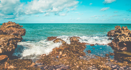 Sea waves hitting rocks on the beach in Coqueirinho,Paraiba, Brazil. Clean Rocks  on Beach 