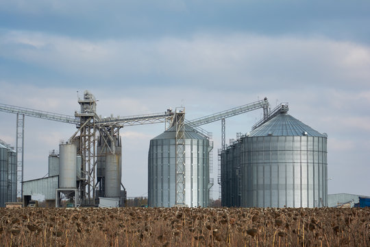 Grain elevator in agricultural zone. Granary with mechanical equipment for receiving, cleaning, drying, grain shipment.