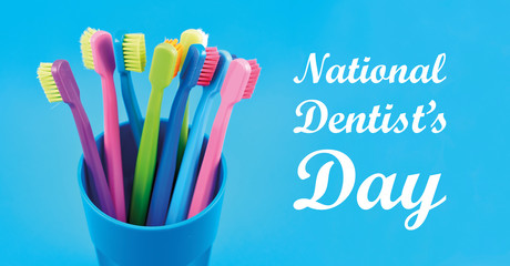 National Dentist's Day images. Colored toothbrushes stock images. Morning hygiene. Bathroom accessories images. Toothbrush on a blue background. March 6, National Dentists Day. Important day