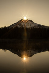 Sunrise over Mt Hood, Oregon's tallest mountain at 11,249 feet (3,429 meters), with Burnt Lake in the foreground.