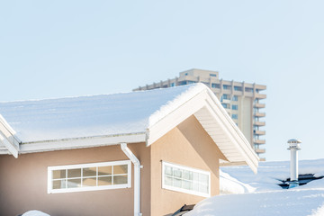 A perfect neighbourhood. Houses in suburb at Winter in the north America. Fragment of a luxury house covered nice snow.