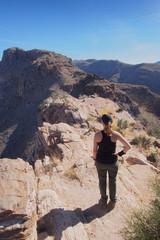 Naklejka na ściany i meble Woman enjoying expansive views at the end of the Blackett's Ridge Trail in the Santa Catalina Mountains near Tucson, Arizona.
