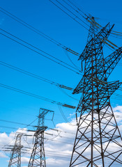  high-voltage  power lines at storm clouds.