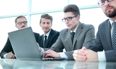 group of business people sitting at an office Desk