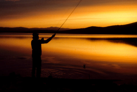 Midnight Fishing at Quartz Lake, Alaska -  A fly fisherman enjoys the peace and quiet of a tranquil lake.