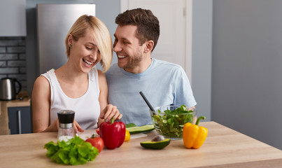 Romantic couple making healthy salad 