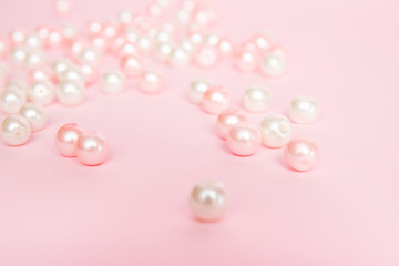 Pink beads on pink background close up