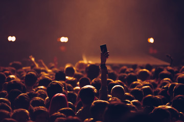 Concert crowd with smart phones in music hall