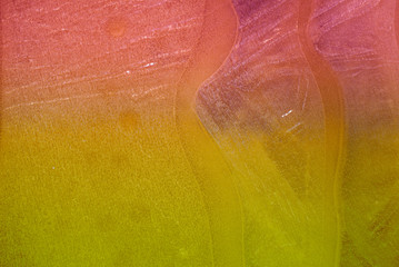 Close up of a colorful ice of a frozen puddle
