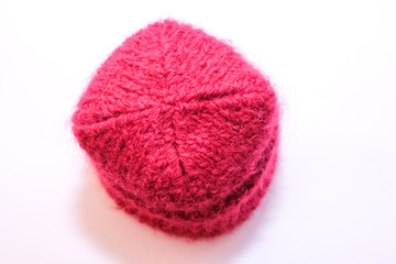 Knitted hat. Bright pink. Top view. Copy space