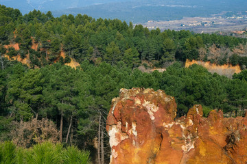 Roussillon, Provence, France. Orange ocher rocks. Pine forest on the rocks.