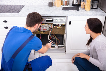 Technician Checking Dishwasher With Digital Multimeter