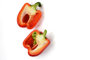 Two half of a bright red raw washed with green tail bulgarian sweet pepper isolated on white background