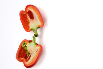 Red sweet pepper cut in half inside longitudinal section isolated on white background