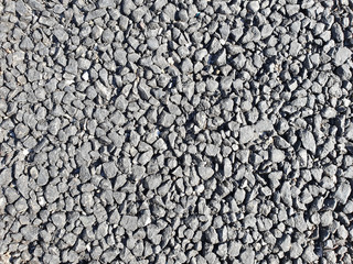 Close-up view road surface of gravel and ashphalt.