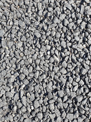Close-up view road surface of gravel and ashphalt.