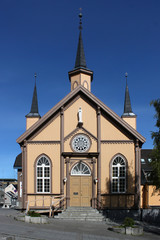 Portal and bell tower on the front facade of the wooden neo-gothic Vår Frue Kirke in Tromso, Norway