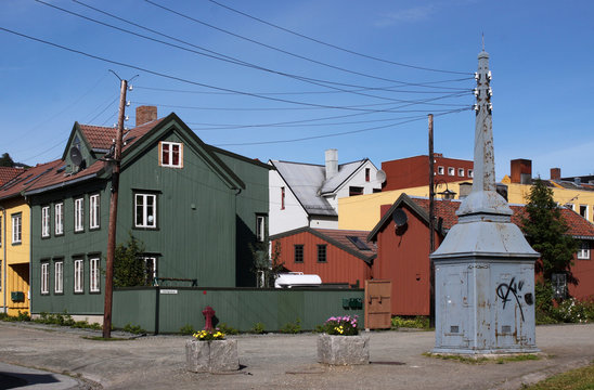 Square with colorful wooden historic houses and old transformer in Tromso, Norway
