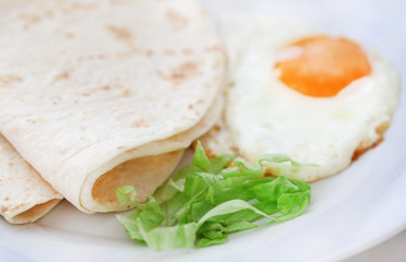 Egg omelet with tortilla bread in a plate
