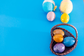 Easter eggs in a wicker basket, top view