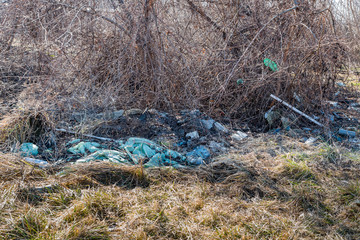 Environment pollution, Garbage dump on the grass near the forest ecological disaster concept polluting nature and city park with litter and junk 