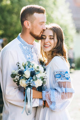 Young beautiful attractive couple smiling and hugging on their anniversary