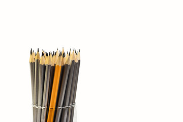 Fototapeta premium Simple pencils for office workers. Pencils for drawing. Pencils are scattered on a white table and stand in a glass. Simple pencils for schoolchildren and students. For business.