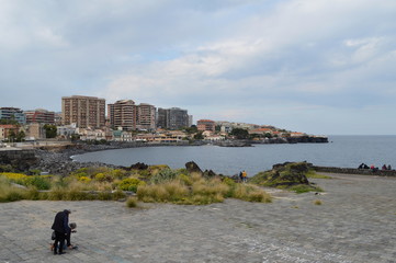 Men with a drone on the shore in Catania, Sicily, Italy