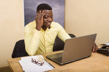 Businessman sitting at a desk with a computer in front of him