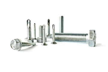 Closeup of different types of fasteners isolated on white. Isolated fasteners. Connecting material...