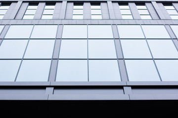 modern office building exterior facade background with wall and windows foreshortening from below