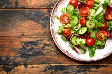 Vegetable salad with tomato and cucumber.Top view with copy space.