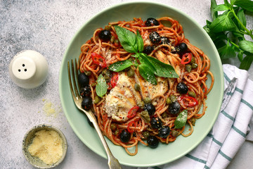 Spaghetti putanesca with chicken.Top view with copy space.