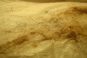 Sugar and cinnamon are mixed and scattered on baking paper. The texture of sugar and cinnamon.