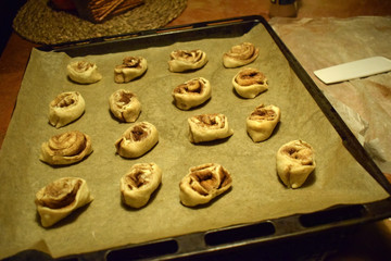 Buns on a baking sheet before baking. Traditional Swedish and Norwegian pastries.