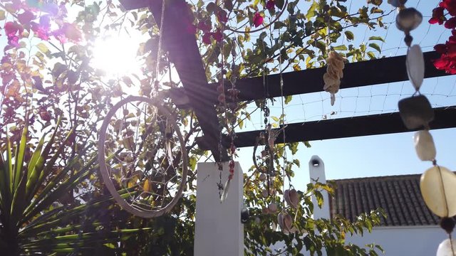 Magic garden with dream catchers in adorable Spanish village. Costa de Luz, Cadiz, Zahora, Spain - slow motion 4k footage
