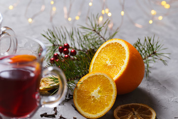 mulled red wine with spices and orange on dark background. warming drink