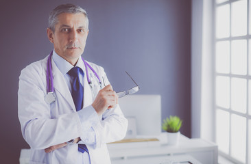 Portrait of a smiling doctor in his bright office