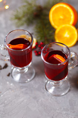 mulled red wine with spices and orange on dark background. warming drink